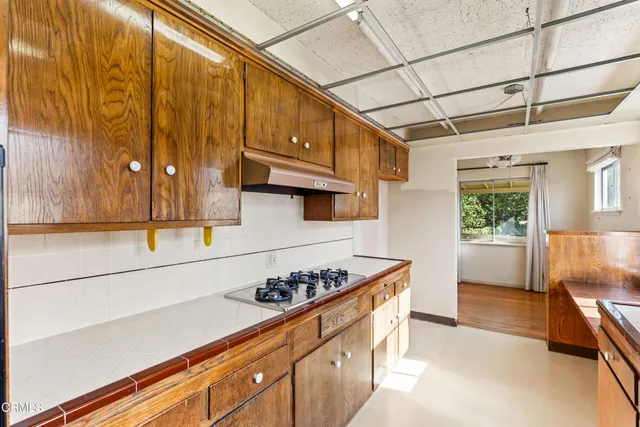 a view of a big room with wooden floor and windows in a room