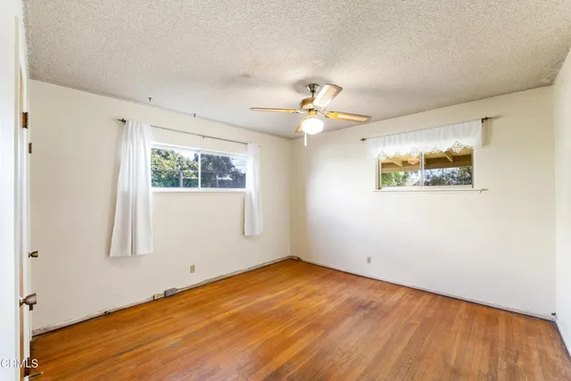 a view of a room with a window and a ceiling fan