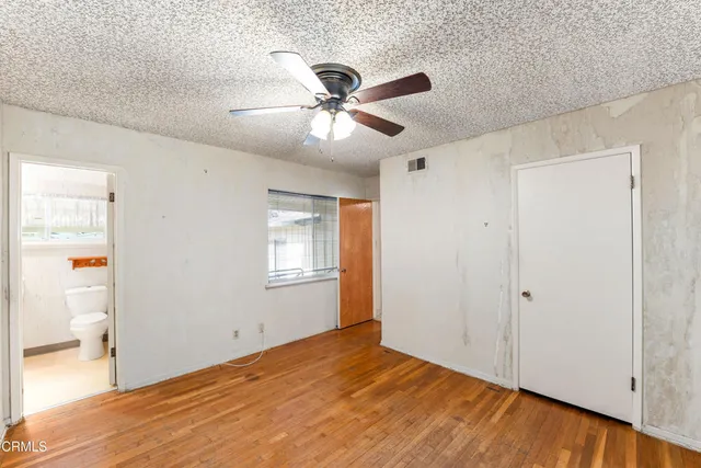 a white toilet sitting next to a bathroom sink and a shower
