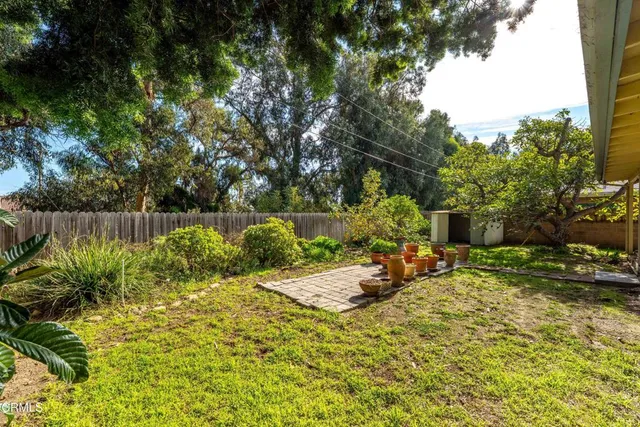 a view of a patio with table and chairs under an umbrella