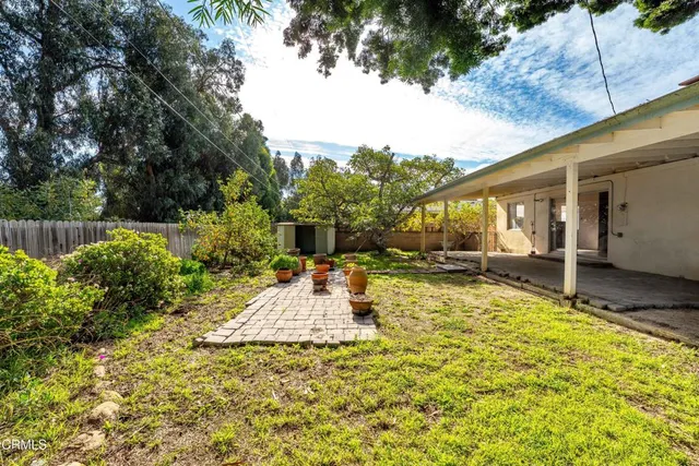 a view of a backyard with a sitting area