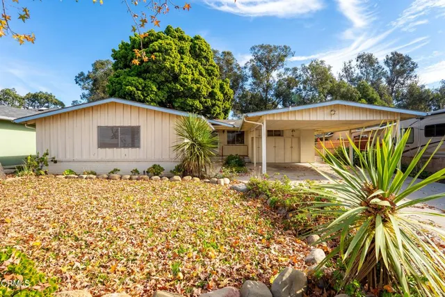 a view of a livingroom with wooden floor a fireplace and window