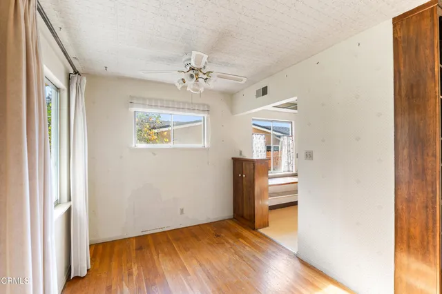 a view of a livingroom with wooden floor and a fireplace