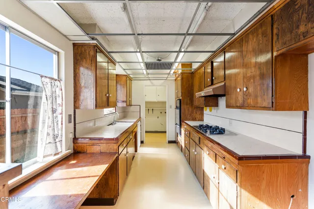 a kitchen with stainless steel appliances a stove a sink and a refrigerator