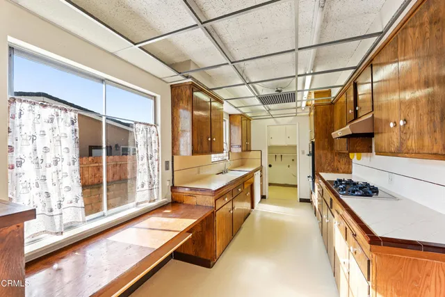 a kitchen with stainless steel appliances granite countertop a sink and wooden cabinets