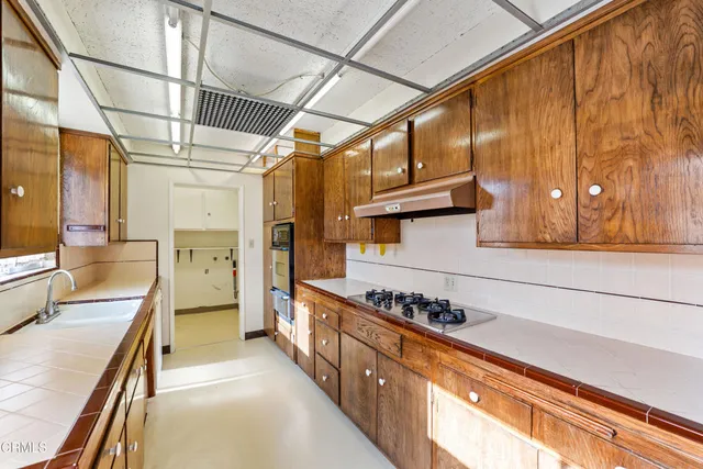 a kitchen with stainless steel appliances granite countertop a sink and a stove