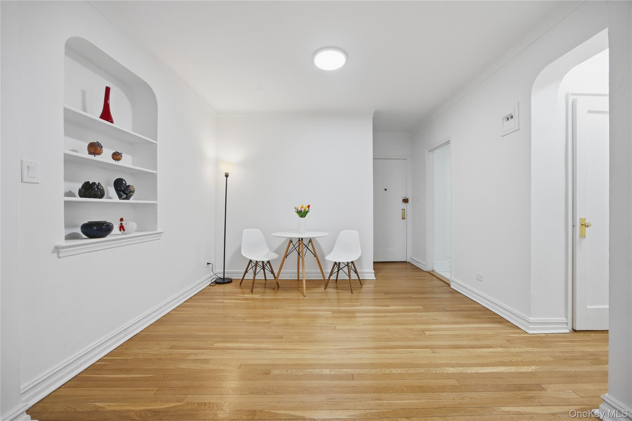 35-35 75th Street, Unit 324 Queens, NY 11372 - Photo 2 of 22 a view of dining room with furniture and wooden floor