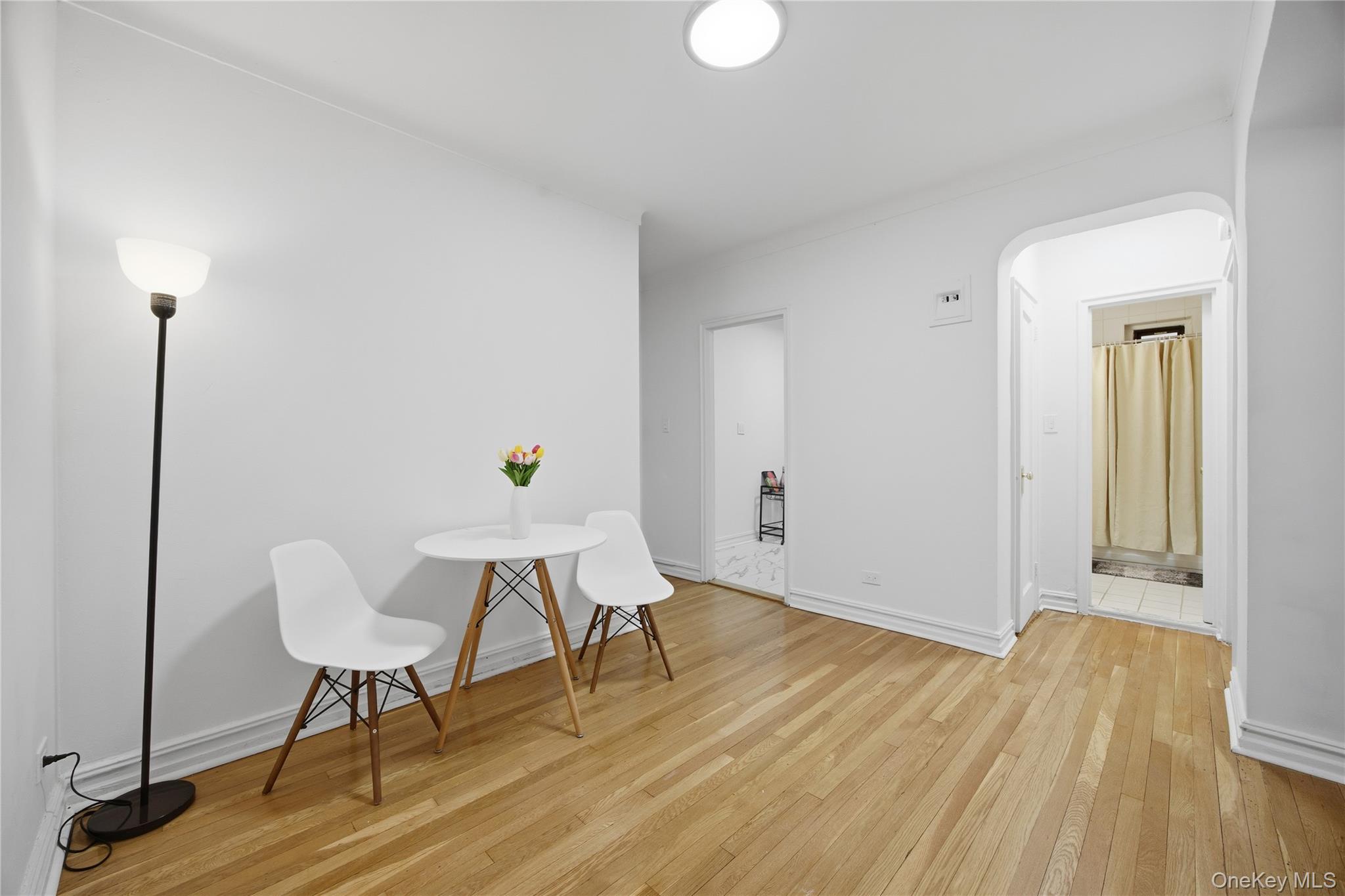 35-35 75th Street, Unit 324 Queens, NY 11372 - Photo 3 of 22 a workspace with furniture and wooden floor