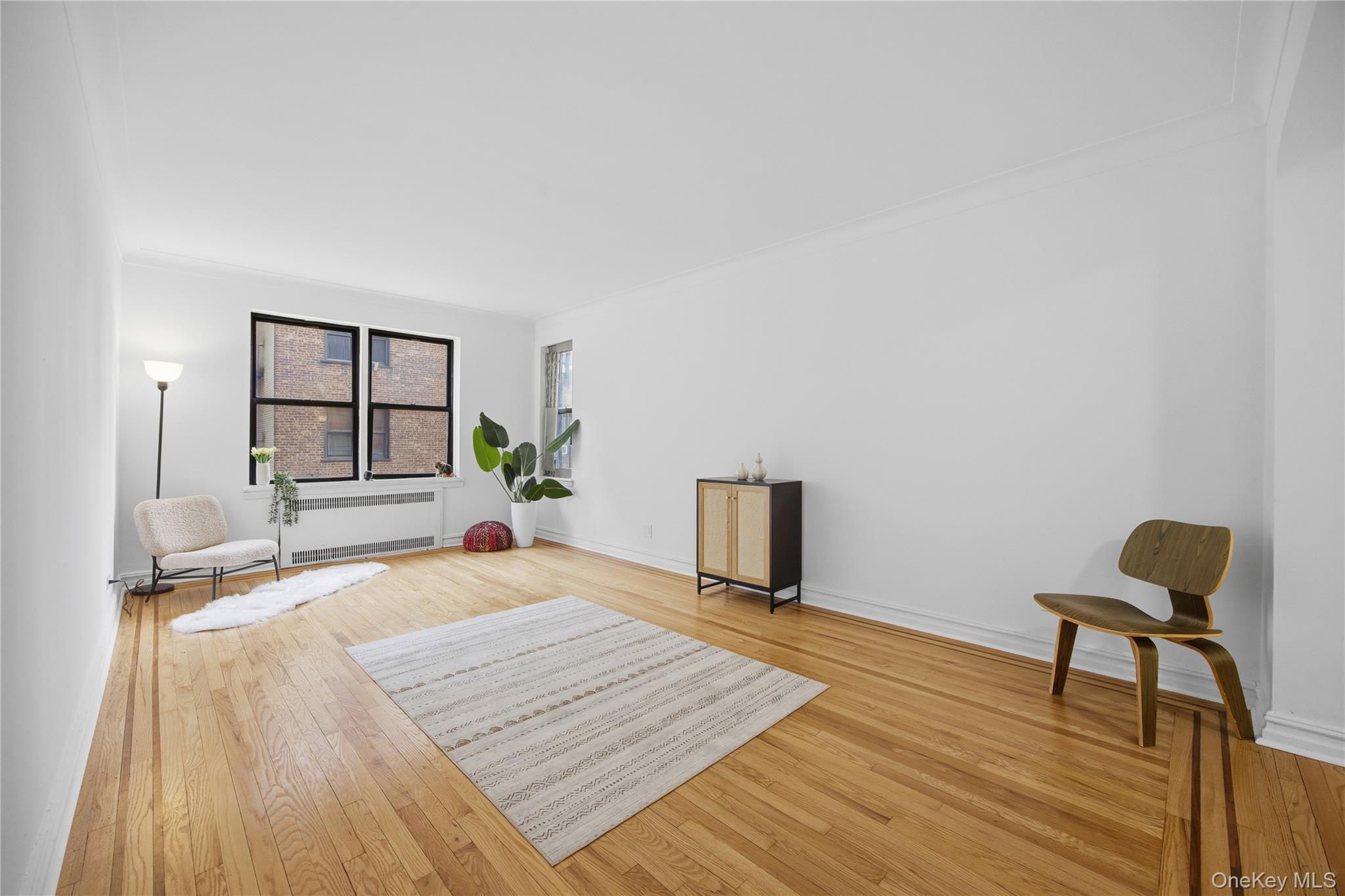 35-35 75th Street, Unit 324 Queens, NY 11372 - Photo 4 of 22 a bedroom with a bed and a window