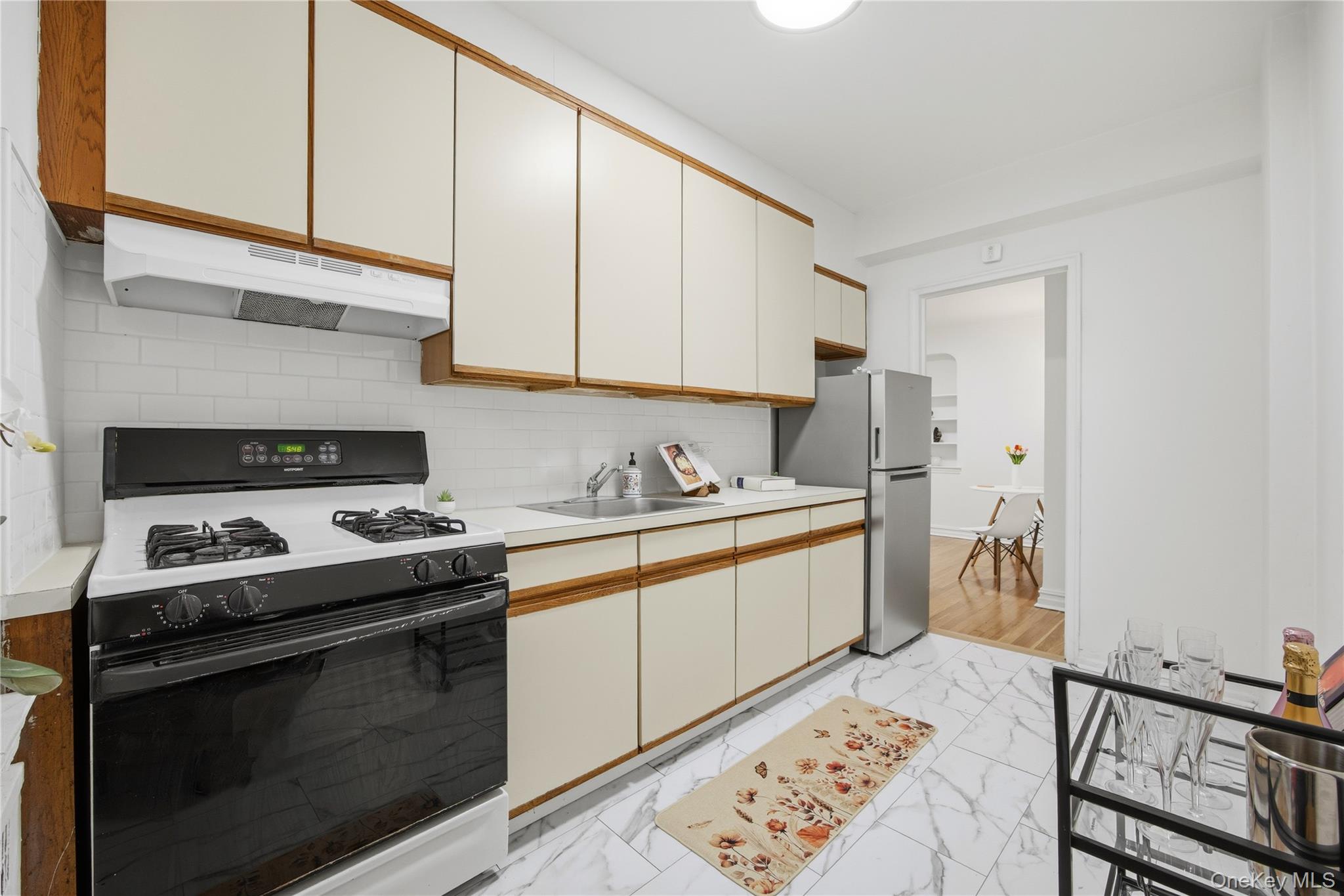35-35 75th Street, Unit 324 Queens, NY 11372 - Photo 10 of 22 a kitchen with stainless steel appliances granite countertop a stove and a sink