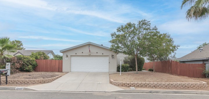 a view of a house with a yard and garage