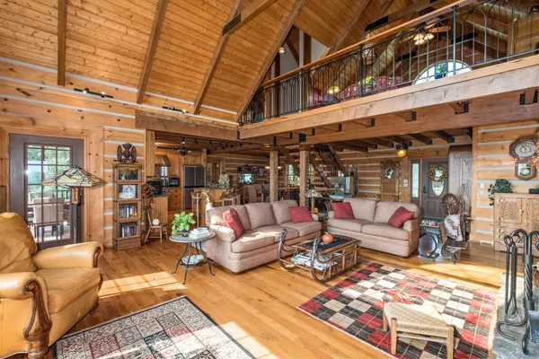 a view of a house with wooden deck and furniture