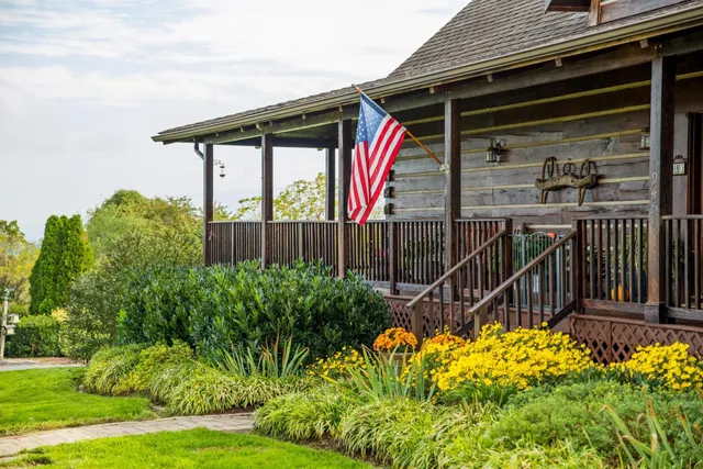 a living room with fireplace furniture and a large window