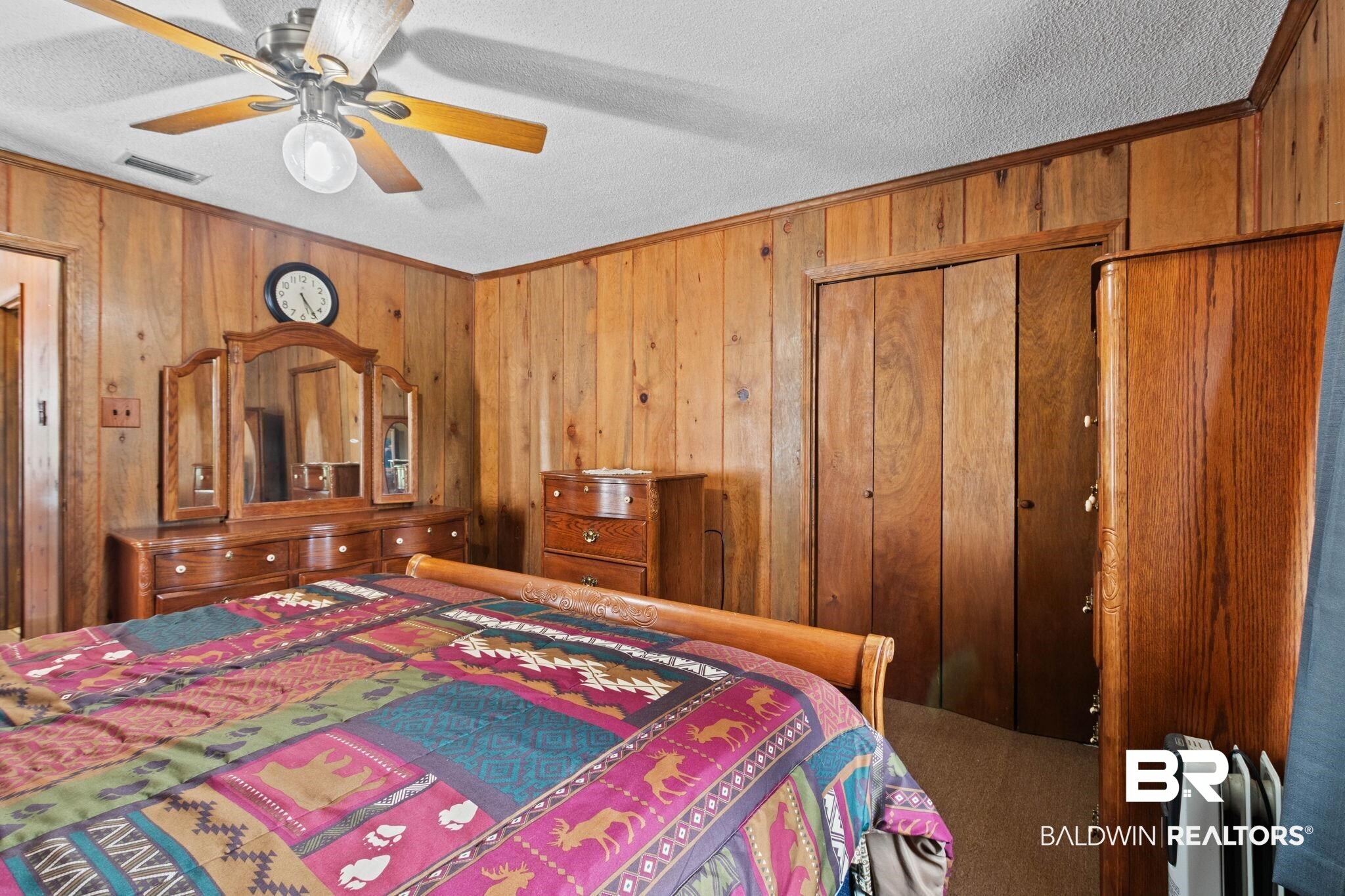8153 Bryant's Lndg Road Stockton, AL 36579 - Photo 37 of 87 Vertical wood paneling, textured ceiling, and a ceiling fan with integrated lighting