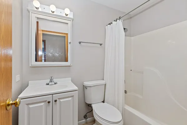 a bathroom with a toilet sink and shower