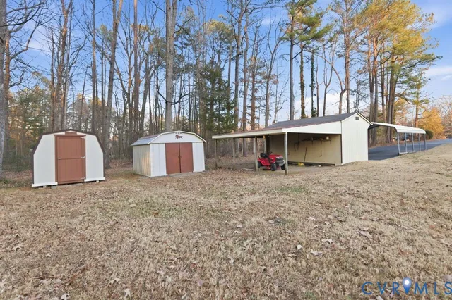 a view of a house with a backyard and tree