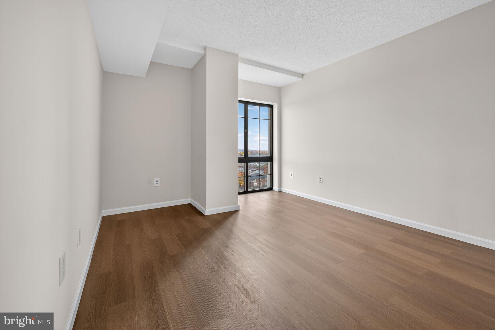7915 Eastern Avenue Northwest, Unit 1114 Silver Spring, MD 20910 - Photo 12 of 34 an empty room with wooden floor and closet