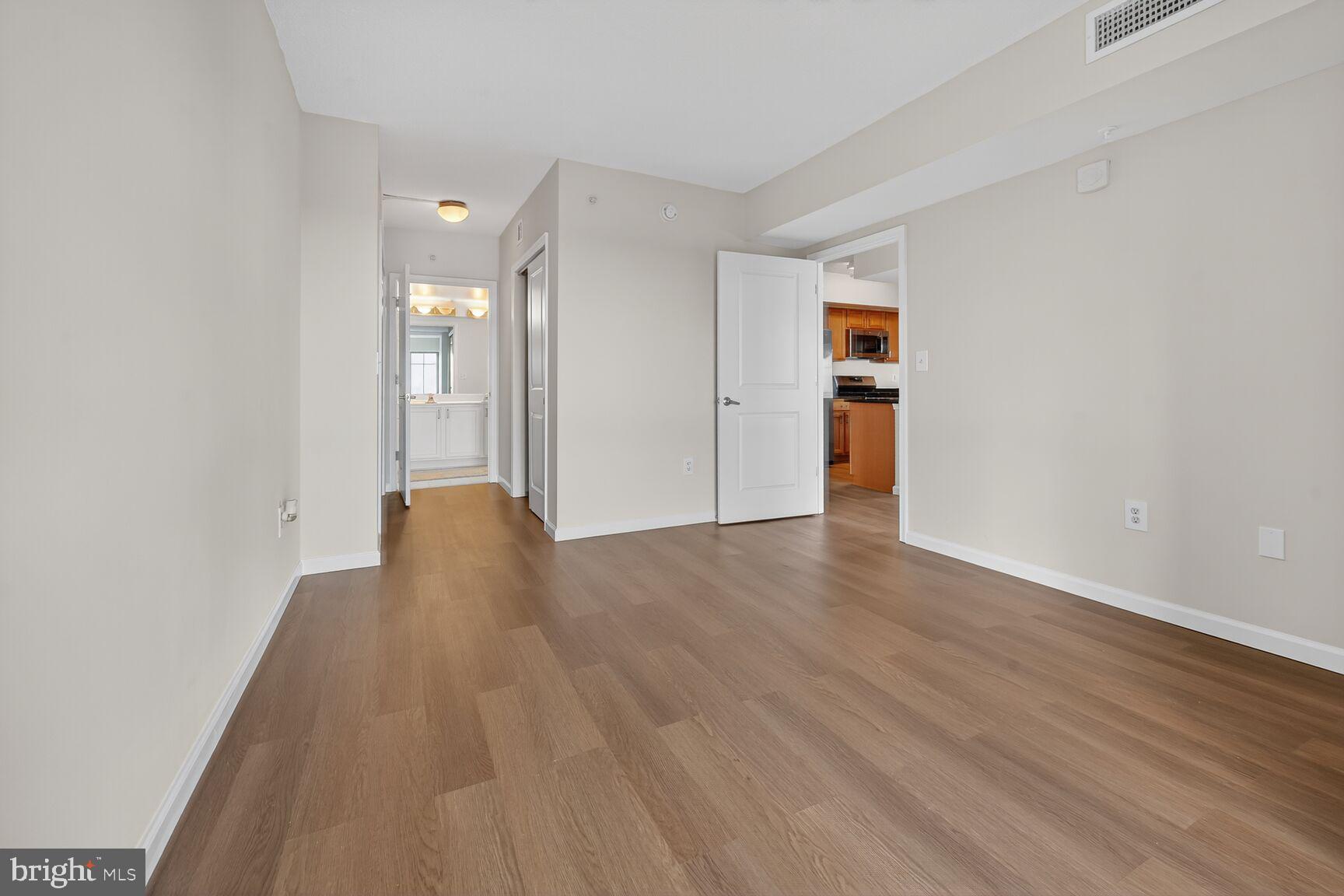 7915 Eastern Avenue Northwest, Unit 1114 Silver Spring, MD 20910 - Photo 14 of 34 wooden floor in an empty room with a window