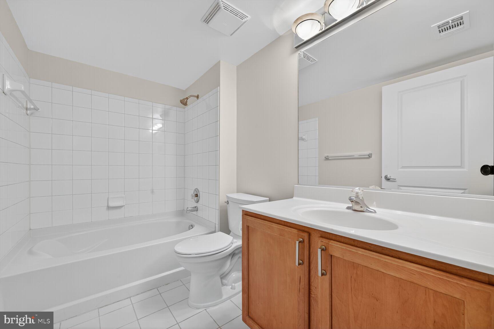 7915 Eastern Avenue Northwest, Unit 1114 Silver Spring, MD 20910 - Photo 19 of 34 a bathroom with a sink a toilet and shower