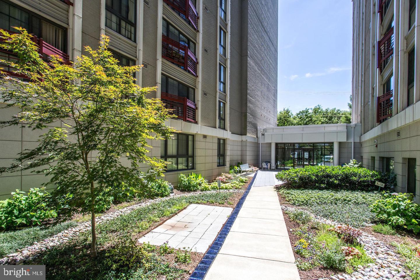 7915 Eastern Avenue Northwest, Unit 1114 Silver Spring, MD 20910 - Photo 26 of 34 a view of a building with a yard and potted plants