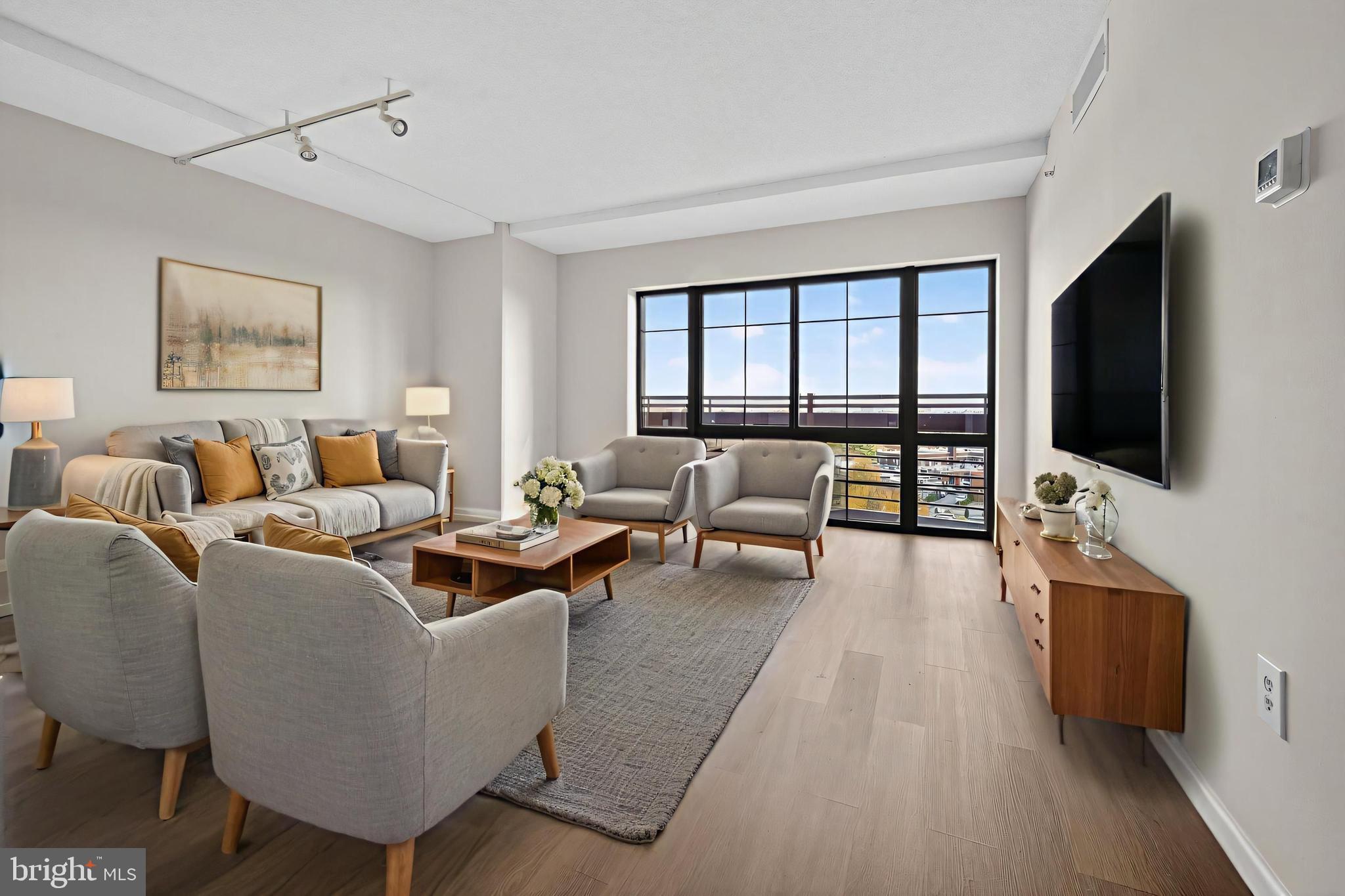 7915 Eastern Avenue Northwest, Unit 1114 Silver Spring, MD 20910 - Photo 5 of 34 a living room with furniture and a flat screen tv