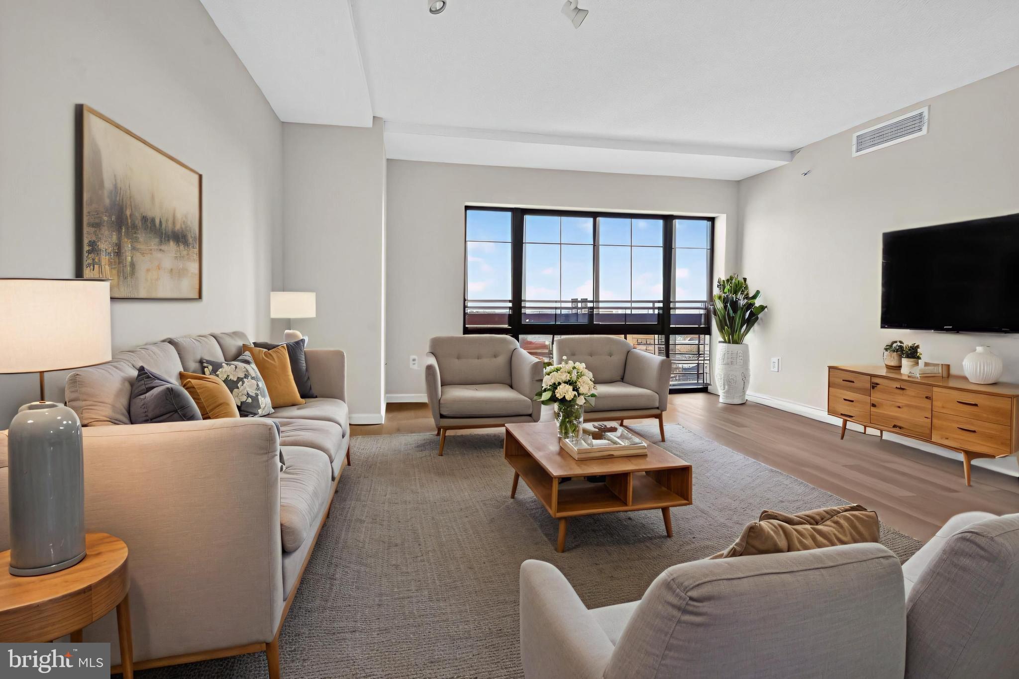 7915 Eastern Avenue Northwest, Unit 1114 Silver Spring, MD 20910 - Photo 6 of 34 a living room with furniture and a flat screen tv