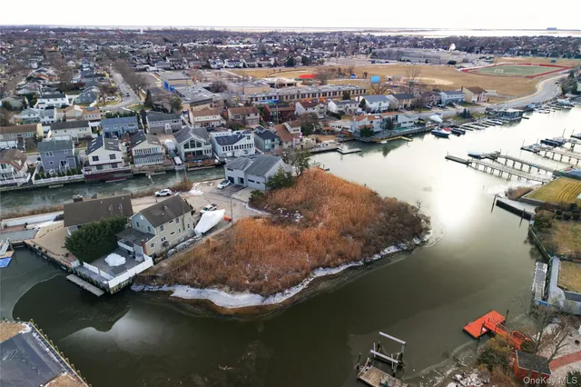 an aerial view of a house with a lake view
