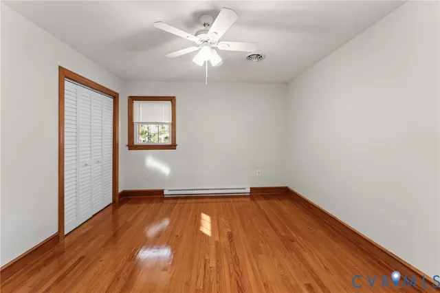 wooden floor in an empty room with a window