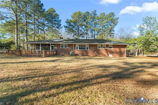 a view of a wooden deck with a yard