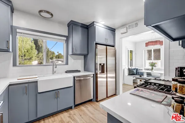 a kitchen with a sink appliances and cabinets