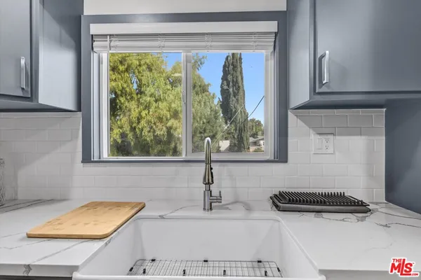 a bathroom with a sink and a window
