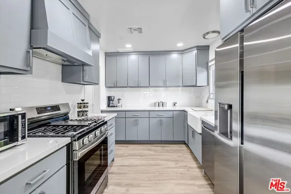 a kitchen with a sink stove and refrigerator