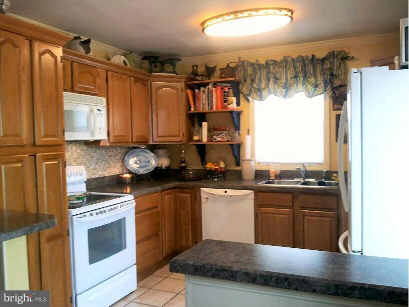 10 Tulip Drive Conowingo, MD 21918 - Photo 19 of 29 a kitchen with stainless steel appliances granite countertop a stove a sink and a microwave