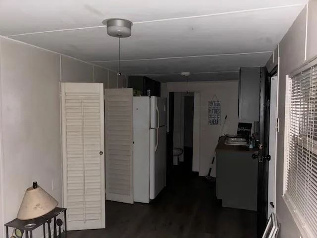 a view of a hallway with couch and wooden floor