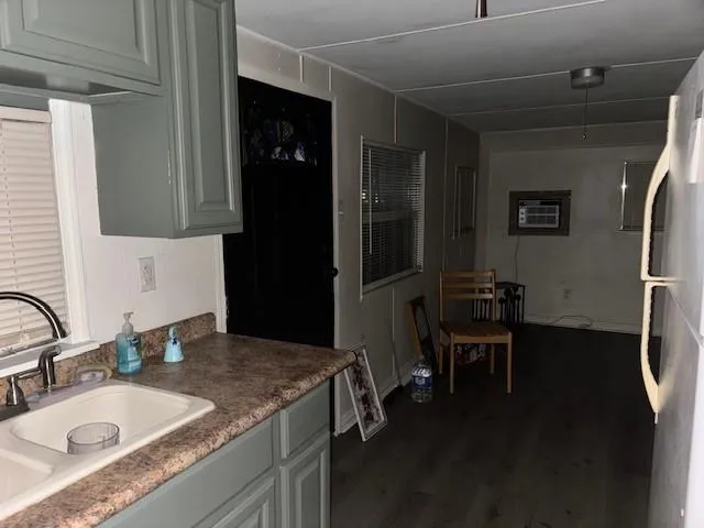 a bathroom with a granite countertop sink a mirror and a shower