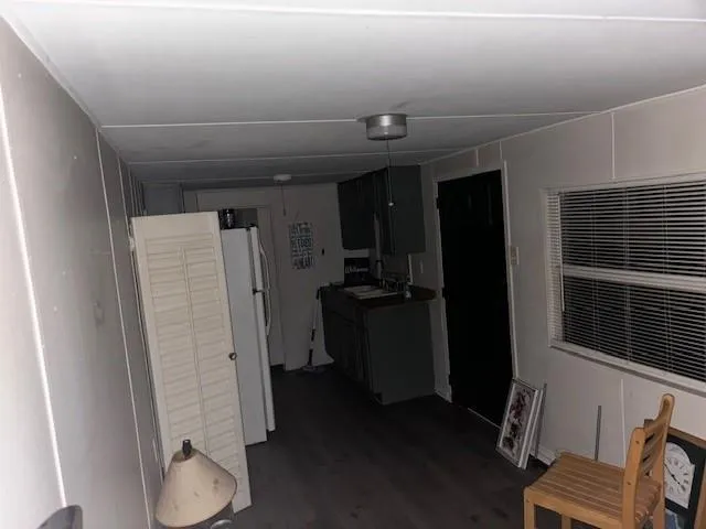 a view of hallway with furniture and a window