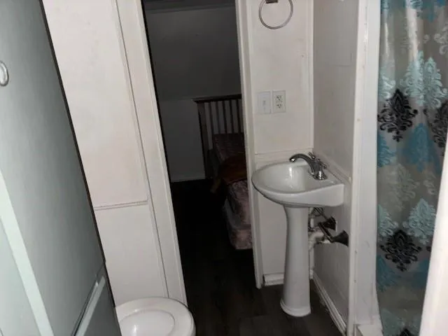 a bathroom with a sink toilet and shower