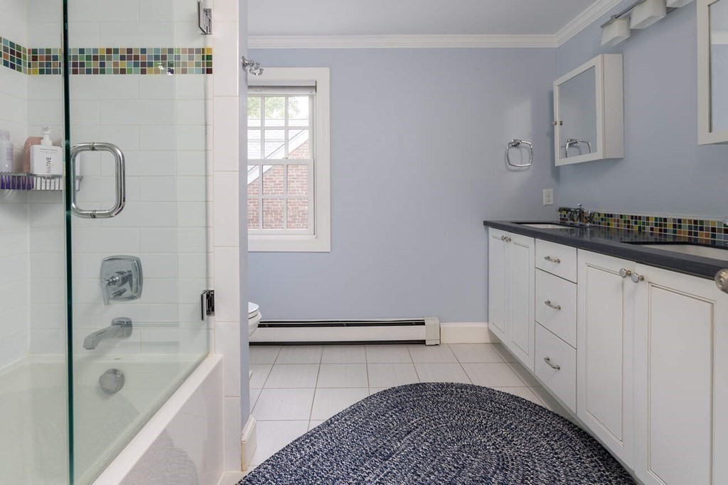 25 Plowgate Road Brookline, MA 02467 - Photo 14 of 19 a spacious bathroom with a granite countertop tub sink a mirror and shower