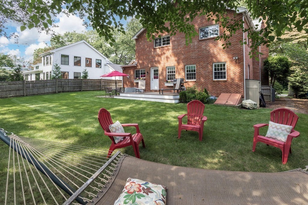 25 Plowgate Road Brookline, MA 02467 - Photo 19 of 19 a front view of a house with a yard table and chairs