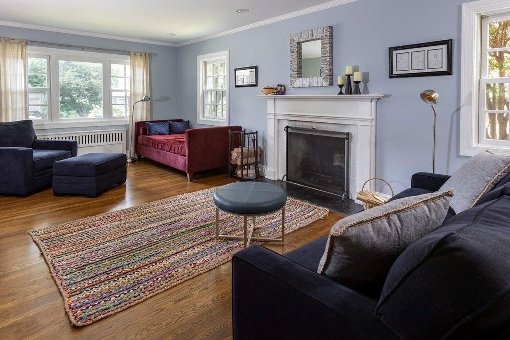 25 Plowgate Road Brookline, MA 02467 - Photo 7 of 19 a living room with furniture and a fireplace