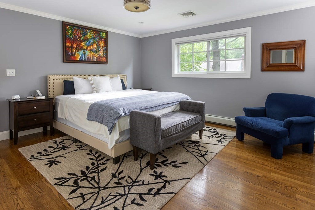 25 Plowgate Road Brookline, MA 02467 - Photo 9 of 19 a bedroom with a bed and wooden floor