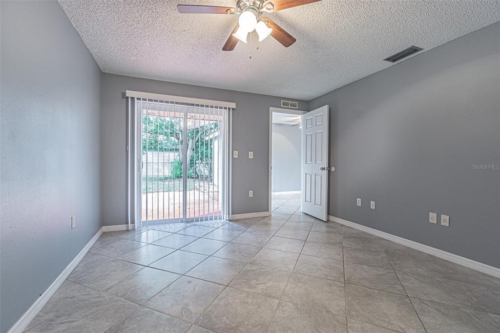 1529 Larkin Road Spring Hill, FL 34608 - Photo 14 of 37 a view of a livingroom with a ceiling fan and window