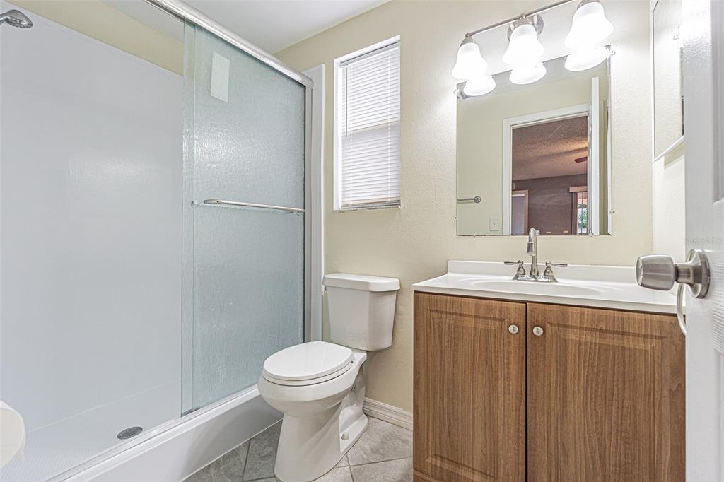 1529 Larkin Road Spring Hill, FL 34608 - Photo 15 of 37 a bathroom with a sink a toilet and shower