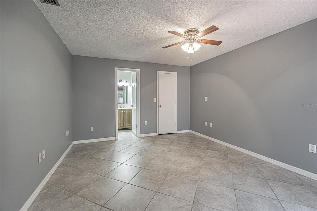 1529 Larkin Road Spring Hill, FL 34608 - Photo 17 of 37 a view of an empty room with a ceiling fan