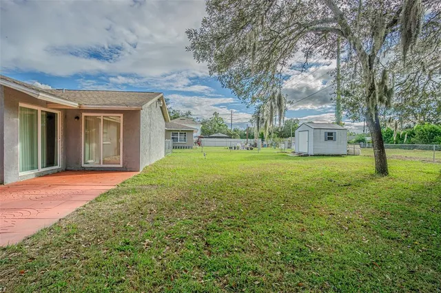 a view of a house with yard and tree s