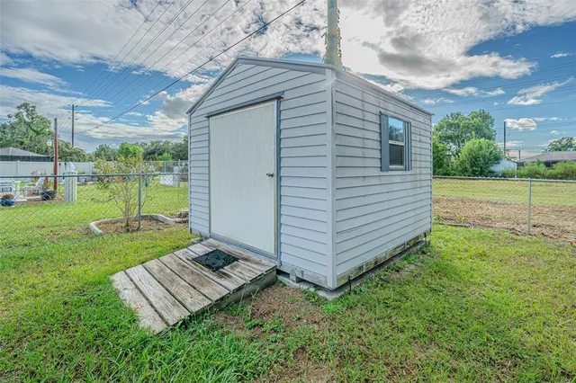 a view of a backyard with wooden fence