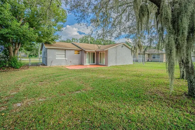 a front view of a house with yard and green space
