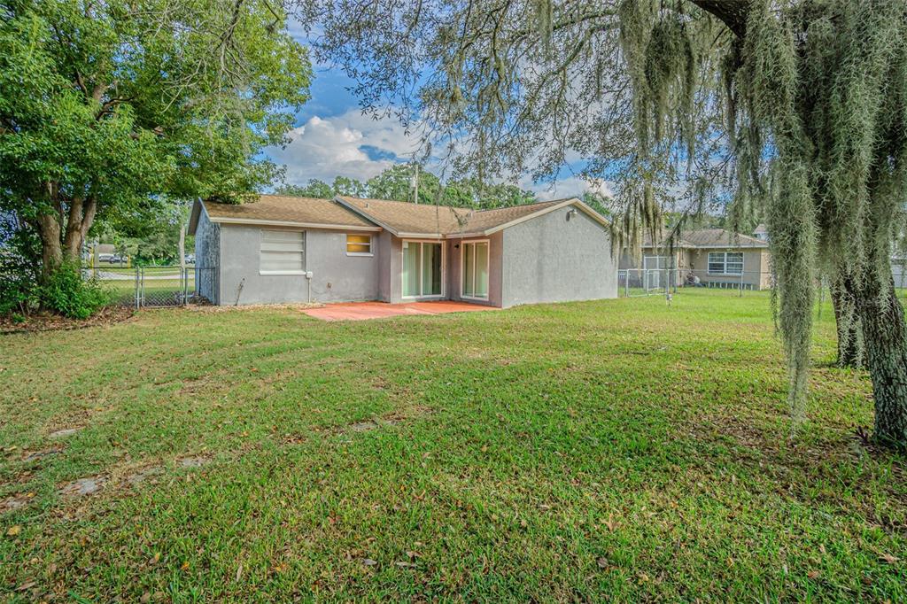 1529 Larkin Road Spring Hill, FL 34608 - Photo 29 of 37 a front view of a house with yard and green space