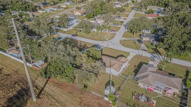 an aerial view of a house with a yard