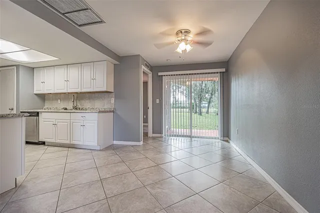 a view of a kitchen with dishwasher and white cabinets
